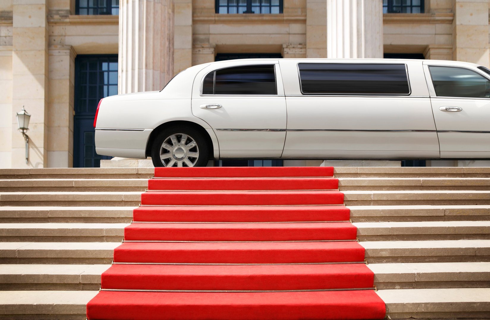 Red carpet with limousine ready for celebrity